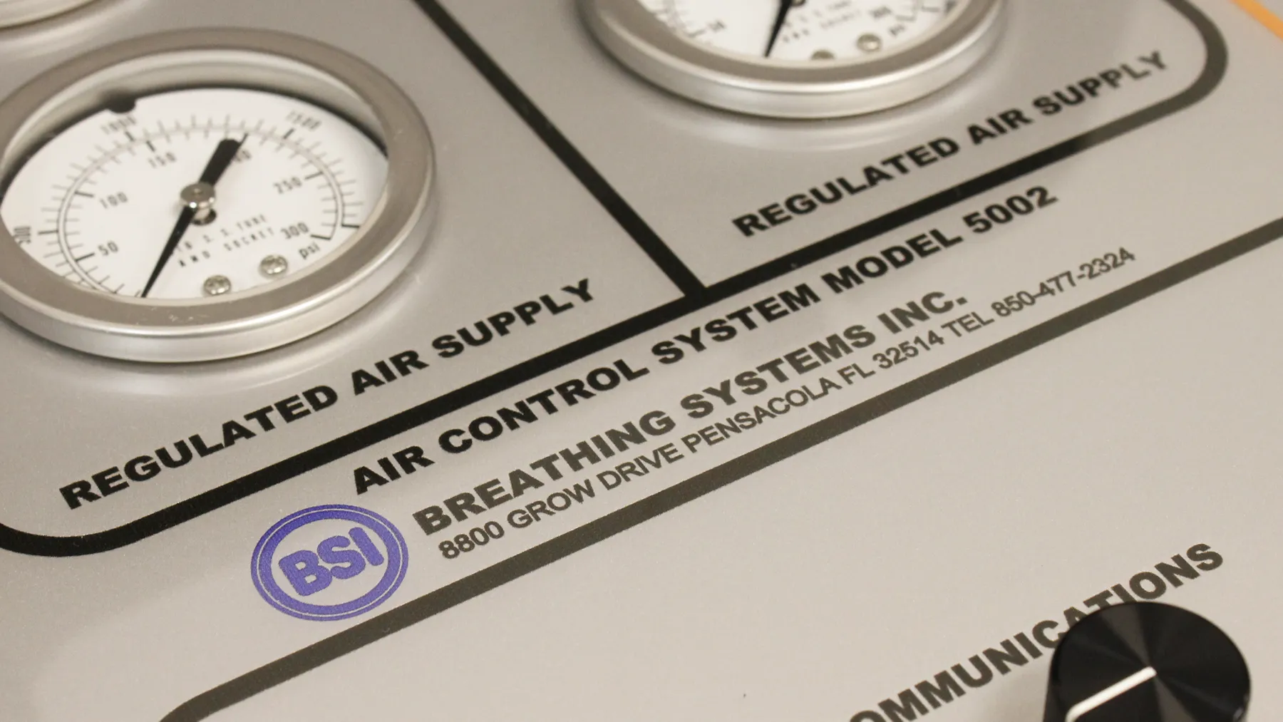 Close-up of a Breathing Systems Air Control System Model 5002 panel, with two regulated-air-supply pressure gauges above the engraved company nameplate.