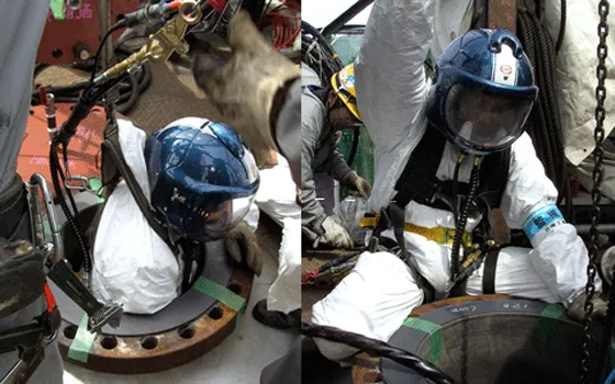 Technicians in confined-space industrial settings wearing BSI clamshell helmets and breathing systems.